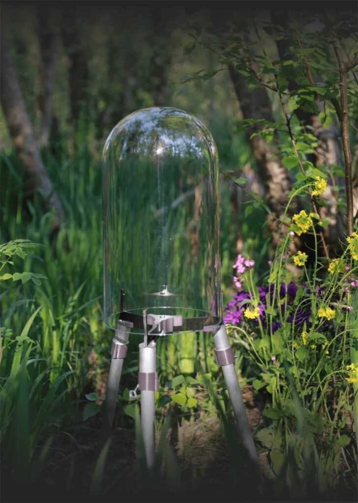 FishView pond dome on aluminium legs in a pond with purple irises