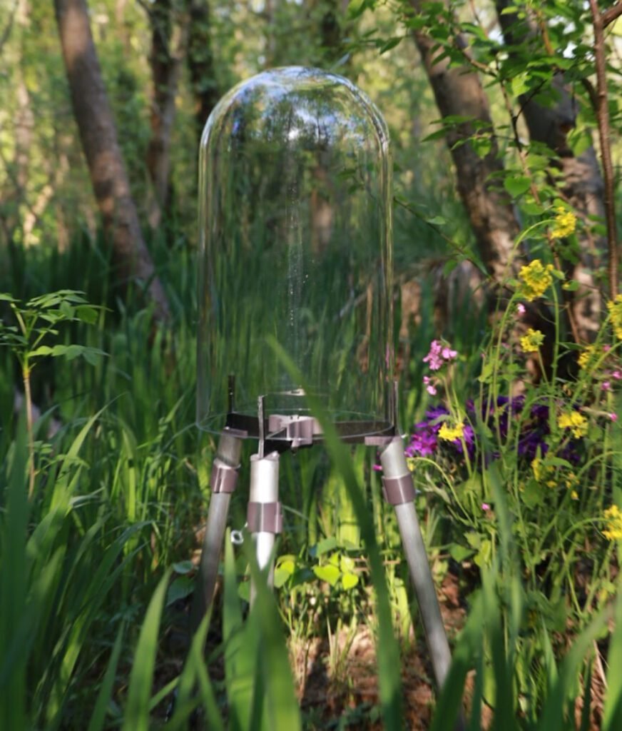 FishView pond dome on aluminium legs in a garden pond with plants